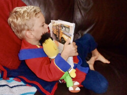 Scott exploring an experience book as a young child.